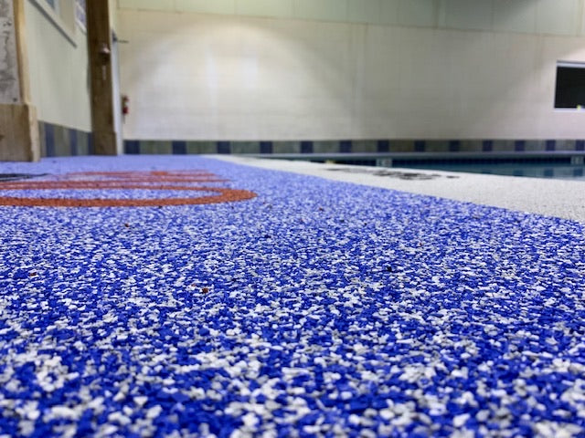 OWA Aquatic Center - After Rubber Surfacing Installation - Close-up of blue and white speckled surface, possibly a pool deck.