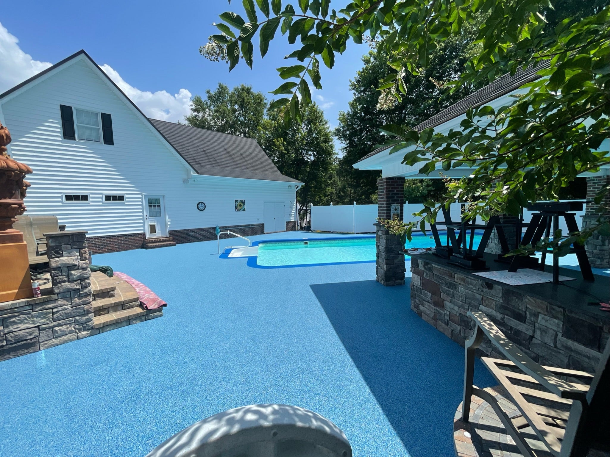 Residential Pool deck - with rubber surfacing - Underground pool with water feature