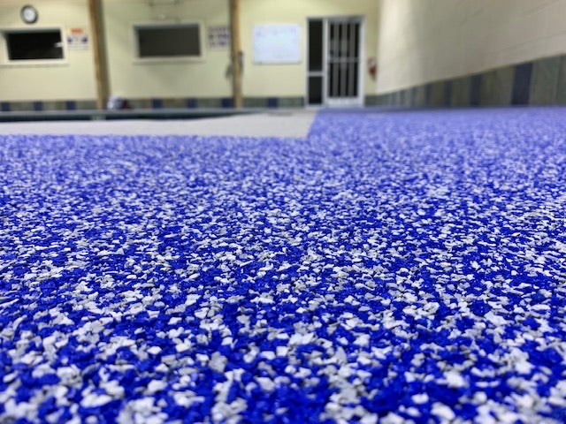 OWA Aquatic Center - After Rubber Surfacing Installation - Close-up of blue and white textured surface, possibly a floor or material sample.
