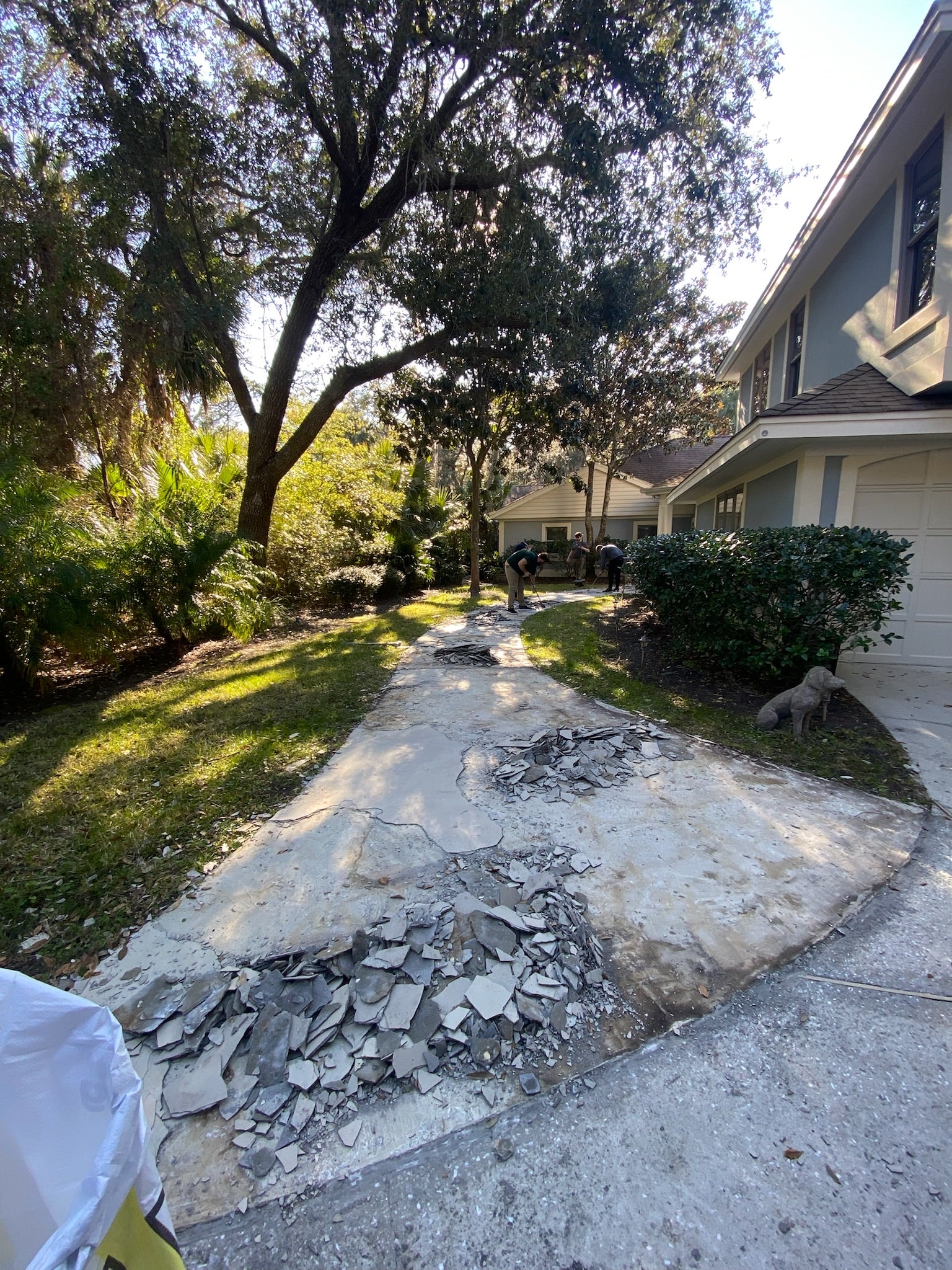 Residential walkway before with no rubber surfacing installed - Demolition with broken concrete and debris in a residential area