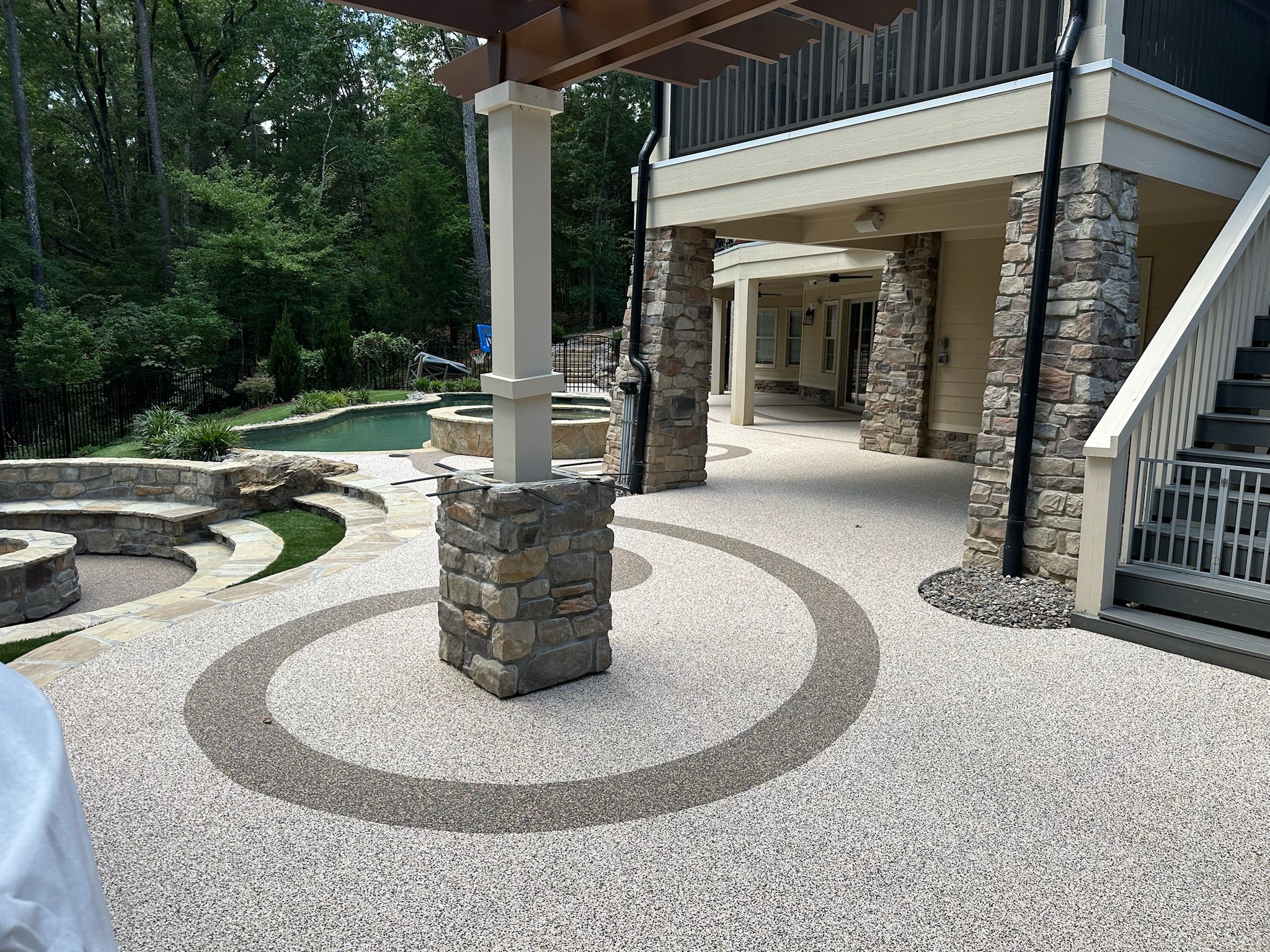Residential Pool Deck - Outdoor patio area with pool and stone columns