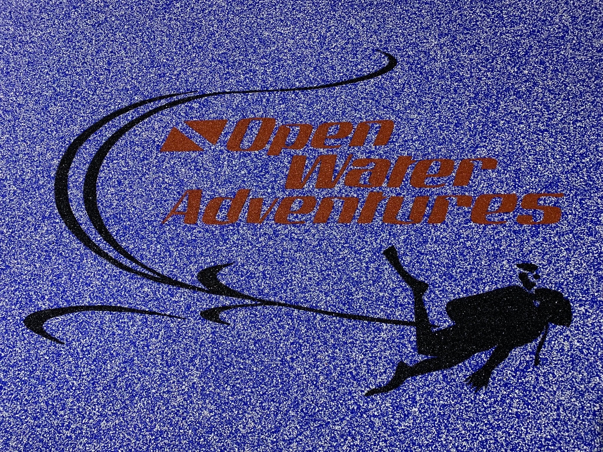 OWA Aquatic Center - After Rubber Surfacing Installation - Open Water Adventures logo with a diver silhouette on a blue textured background