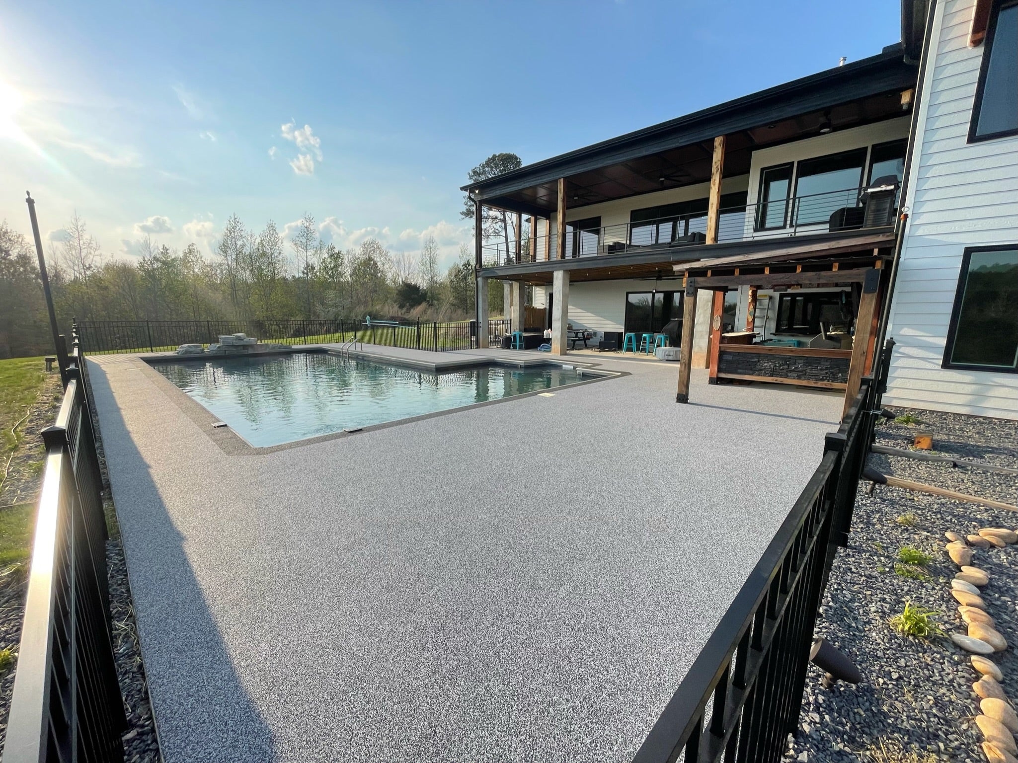 Residential Pool deck - with rubber surfacing - Underground pool backyard of luxury home